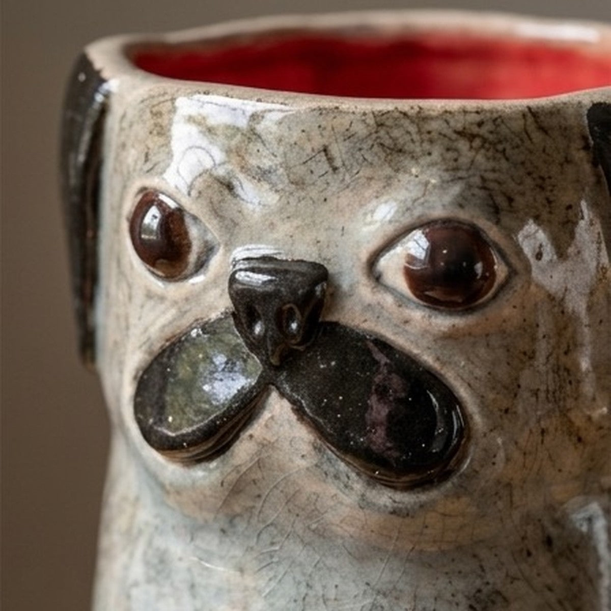 Archie the black pug ceramic vase, close-up of the face