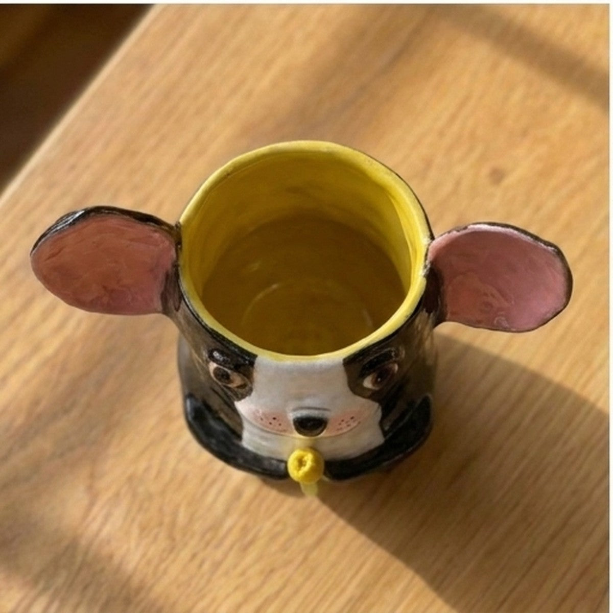 Clara the Boston Terrier ceramic vase, top-down view showing the yellow glazed interior