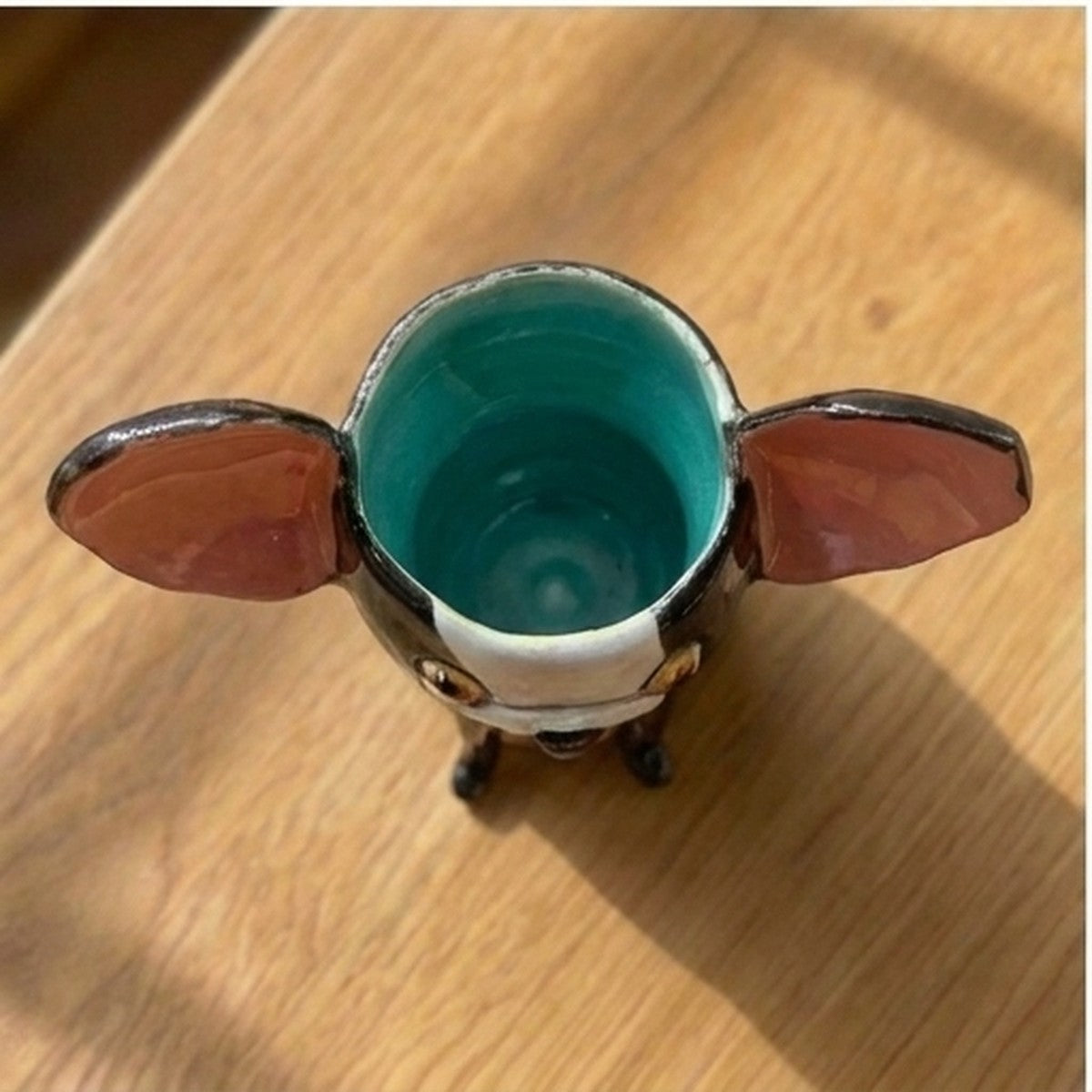 Edwin the Boston Terrier ceramic vase, top-down view showing the teal glazed interior