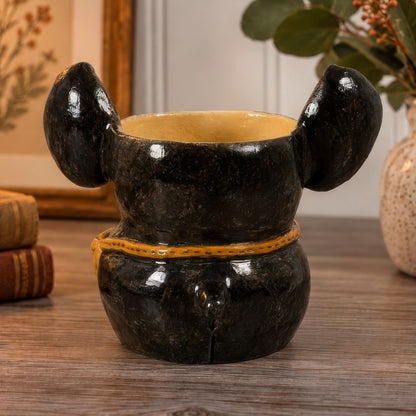 Fletcher, a handmade ceramic Boston Terrier vase, back view with black ears, satchel strap and a little tail