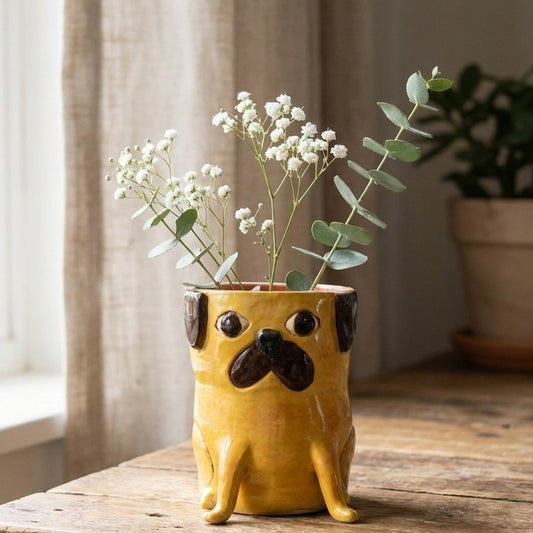 Gus the apricot pug ceramic vase with baby's breath and eucalyptus