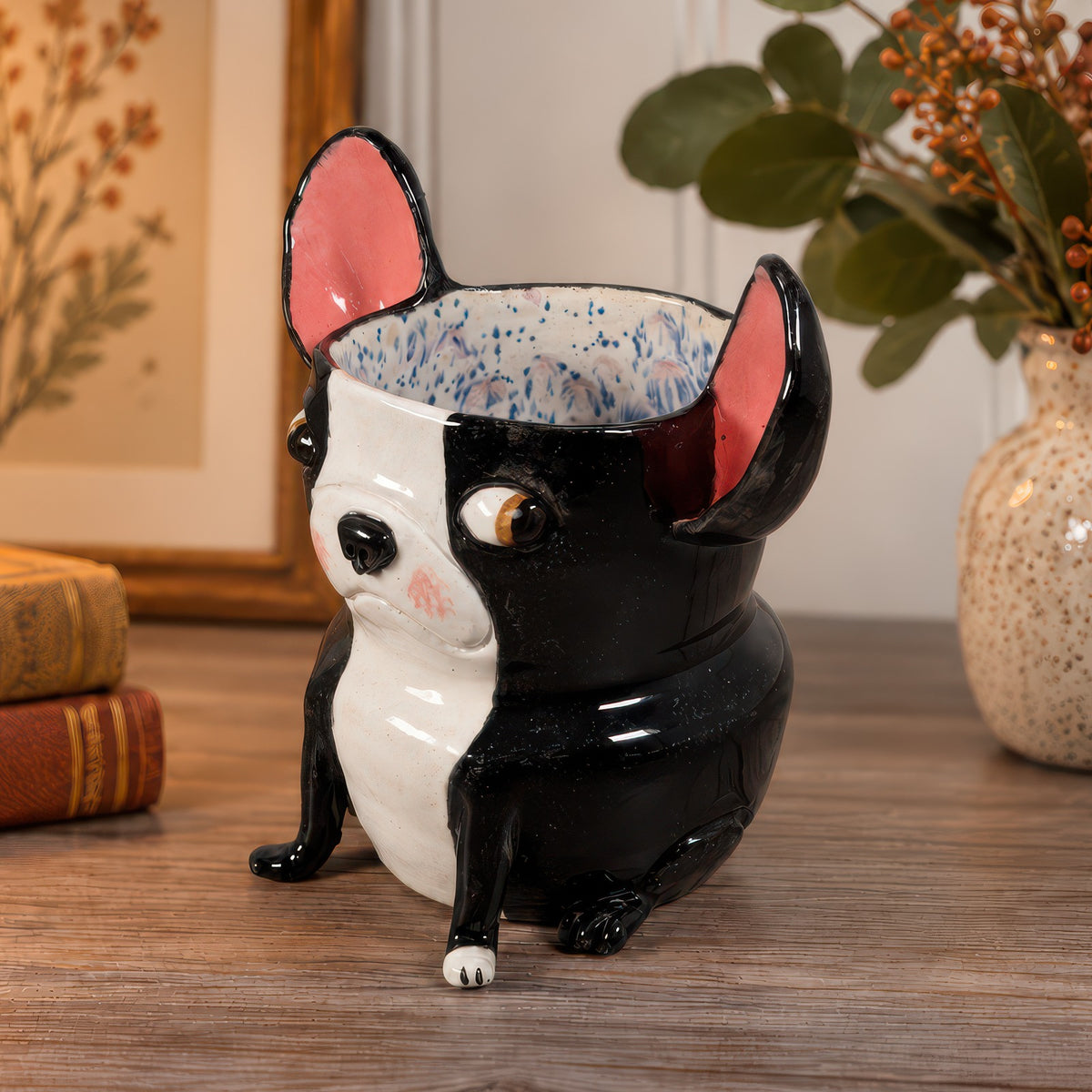 Norman, a handmade ceramic Boston Terrier vase, side view showing his sitting pose and speckled blue glaze inside