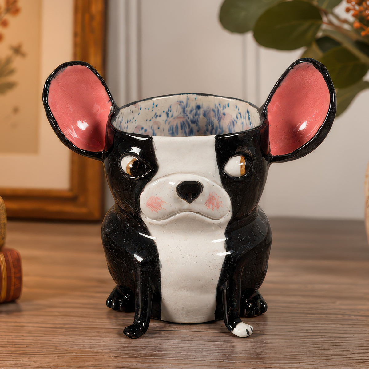 Norman, a handmade ceramic Boston Terrier vase with pink ears, giving a skeptical sideways glance
