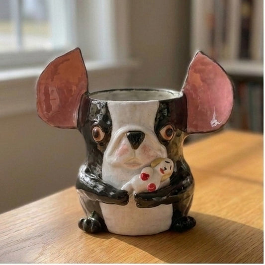 Theo the Boston Terrier ceramic vase holding a small bunny figure, front view